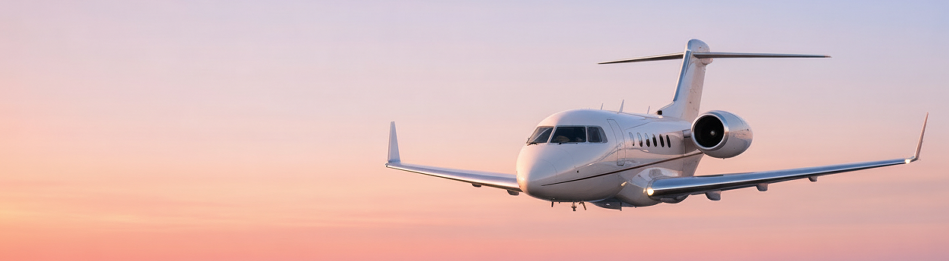Private jet on a runway with a scenic sky backdrop
